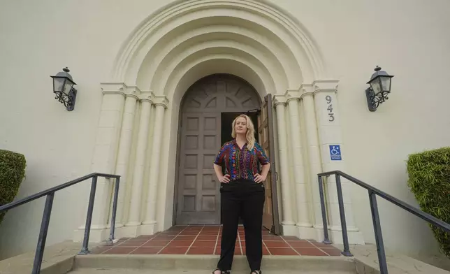 Pastor Ruth Schmidt poses for a picture at the Altadena Community Church in Altadena, Calif., on Tuesday, May 21, 2024. Schmidt, who now serves as a pastor at Claremont Presbyterian Church and is on track to be ordained in the United Church of Christ, said she would like to see faculty and staff at Fuller get the same protections as students. Fuller Theological Seminary, an evangelical school is deliberating whether to become more open to LGBTQ+ students who previously faced possible expulsion if found to be in a same-sex union. (AP Photo/Damian Dovarganes)