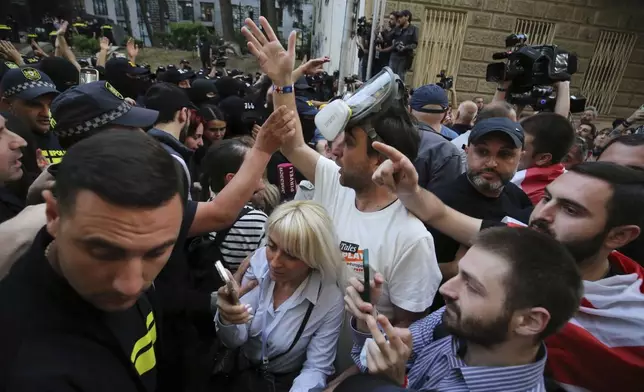 Demonstrators argue with police that blocked them during an opposition protest against "the Russian law" near the Parliament building in Tbilisi, Georgia, on Wednesday, May 1, 2024. Protesters denounce the bill as "the Russian law" because Moscow uses similar legislation to stigmatize independent news media and organizations critical of the Kremlin. (AP Photo/Zurab Tsertsvadze)