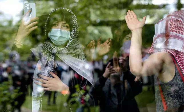 Protesters are seen during a pro-Palestinians demonstration by the group "Student Coalition Berlin" in the theater courtyard of the 'Freie Universität Berlin' university in Berlin, Germany, Tuesday, May 7, 2024. Pro-Palestinian activists occupied a courtyard of the Free University in Berlin on Tuesday. (AP Photo/Markus Schreiber)