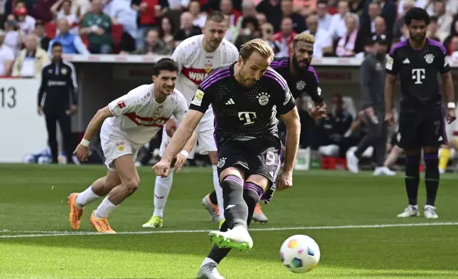 Munich's Harry Kane scores from the penalty spot, during the German Bundesliga soccer match between Bayern Munich and VfB Stuttgart, in Stuttgart, Germany, Saturday, May 4, 2024. (Bernd Wei'brod/dpa via AP)