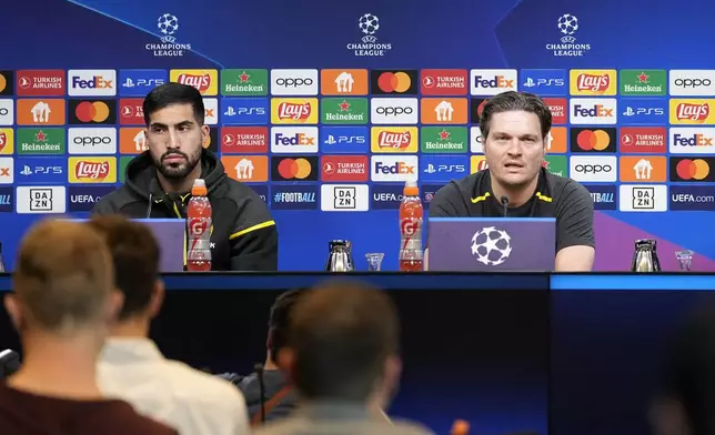 Dortmund's head coach Edin Terzic, right, talks to the media beside Dortmund's Emre Can, left, at a press conference prior the Champions League semifinal first leg soccer match between Borussia Dortmund and Paris Saint-Germain at the Signal-Iduna Park in Dortmund, Germany, Tuesday, April 30, 2024. (AP Photo/Martin Meissner)