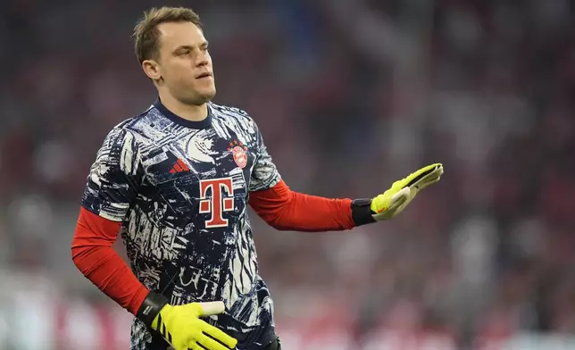 Bayern's goalkeeper Manuel Neuer applauds fans as he warms up prior to the Champions League semifinal first leg soccer match between Bayern Munich and Real Madrid at the Allianz Arena in Munich, Germany, Tuesday, April 30, 2024. (AP Photo/Matthias Schrader)