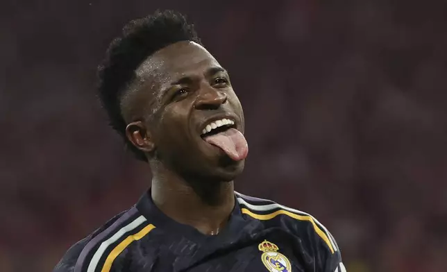 Madrid's Vinicius Junior celebrates after scoring his side's second goal by penalty during the Champions League, semifinal first leg, soccer match between FC Bayern Munich and Real Madrid in Munich, Germany, Tuesday, April 30, 2024. (Matthias Balk/dpa via AP)