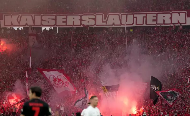 Kaiserslautern supporters cheer their team during the German Soccer Cup final match between 1. FC Kaiserslautern and Bayer Leverkusen at the Olympic Stadium in Berlin, Germany, Saturday, May 25, 2024. (AP Photo/Matthias Schrader)
