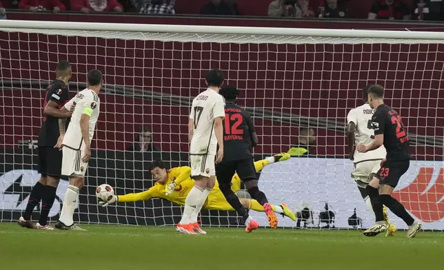 Roma's goalkeeper Mile Svilar saves the ball during the Europa League second leg semi-final soccer match between Leverkusen and Roma at the BayArena in Leverkusen, Germany, Thursday, May 9, 2024. (AP Photo/Matthias Schrader)