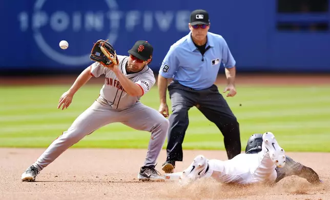 New York Mets' Tyrone Taylor steals second base against San Francisco Giants second baseman Brett Wisely (0) during the seventh inning of a baseball game, Saturday, May 25, 2024, in New York. (AP Photo/Noah K. Murray)