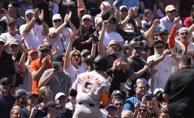 San Francisco Giants fans cheer after a solo home run by Mike Yastrzemski (5) during the third inning of a baseball game against the Boston Red Sox at Fenway Park, Thursday, May 2, 2024, in Boston. (AP Photo/Charles Krupa)
