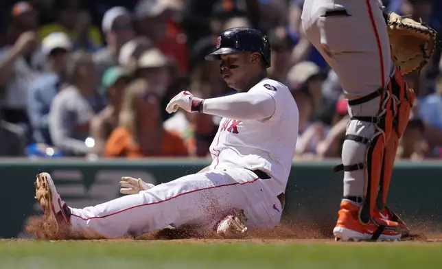 Boston Red Sox's Rafael Devers scores on a double by Tyler O'Neill during the third inning of a baseball game against the San Francisco Giants at Fenway Park, Thursday, May 2, 2024, in Boston. (AP Photo/Charles Krupa)
