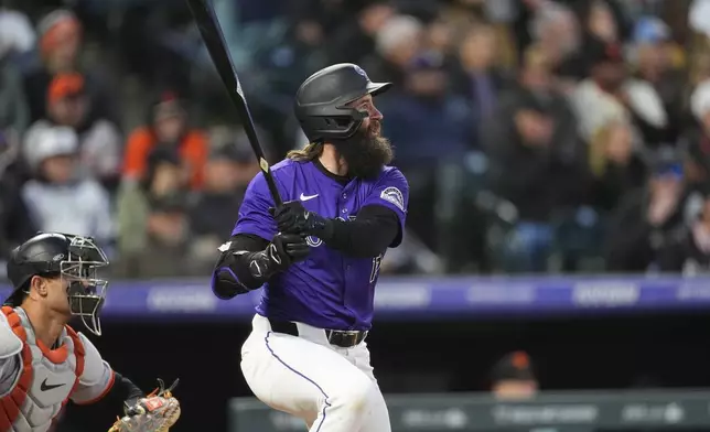Colorado Rockies' Charlie Blackmon follows the flight of his RBI single off San Francisco Giants starting pitcher Jordan Hicks in the fifth inning of a baseball game Wednesday, May 8, 2024, in Denver. (AP Photo/David Zalubowski)