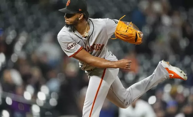 San Francisco Giants relief pitcher Camilo Doval works against the Colorado Rockies in the ninth inning of a baseball game Tuesday, May 7, 2024, in Denver. (AP Photo/David Zalubowski)
