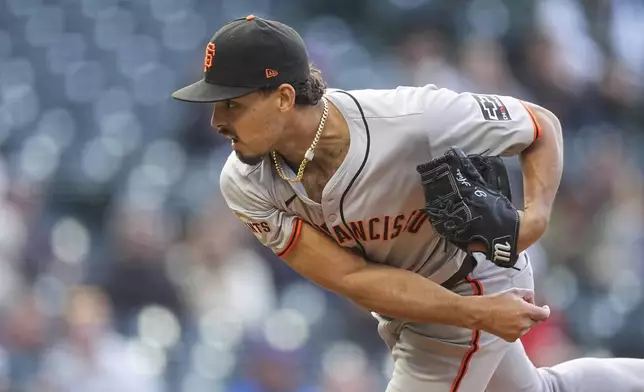 San Francisco Giants starting pitcher Jordan Hicks works against the Colorado Rockies during the first inning of a baseball game Wednesday, May 8, 2024, in Denver. (AP Photo/David Zalubowski)