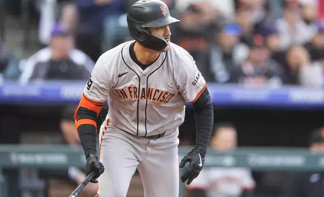 San Francisco Giants' Michael Conforto breaks from the batter's box after singling off Colorado Rockies starting pitcher Peter Lambert during the second inning of a baseball game Wednesday, May 8, 2024, in Denver. (AP Photo/David Zalubowski)