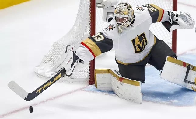 Vegas Golden Knights goaltender Adin Hill deflects a shot during the first period in Game 7 of an NHL hockey Stanley Cup first-round playoff series against the Dallas Stars, Sunday, May 5, 2024, in Dallas. (AP Photo/Brandon Wade)