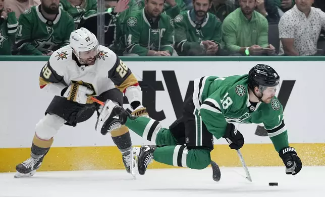 Dallas Stars center Sam Steel (18) is tripped by Vegas Golden Knights' William Carrier (28) in the first period in Game 5 of an NHL hockey Stanley Cup first-round playoff series in Dallas, Wednesday, May 1, 2024. Carrier was issued a penalty on the play. (AP Photo/Tony Gutierrez)