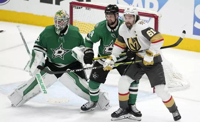 Dallas Stars goaltender Jake Oettinger, left, and left wing Jamie Benn (1) defend the net against pressure from Vegas Golden Knights right wing Mark Stone (61) in the third period in Game 5 of an NHL hockey Stanley Cup first-round playoff series in Dallas, Wednesday, May 1, 2024. (AP Photo/Tony Gutierrez)