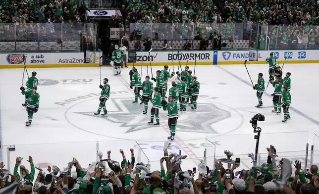 Dallas Stars players acknowledge spectators following their 2-1 victory over the Vegas Golden Knights in Game 7 of an NHL hockey Stanley Cup first-round playoff series, Sunday, May 5, 2024, in Dallas. (AP Photo/Brandon Wade)