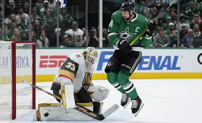 Vegas Golden Knights goaltender Adin Hill (33) blocks a shot under pressure from Dallas Stars left wing Jamie Benn (14) in the first period in Game 5 of an NHL hockey Stanley Cup first-round playoff series in Dallas, Wednesday, May 1, 2024. (AP Photo/Tony Gutierrez)