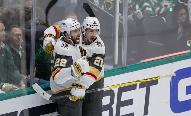 Vegas Golden Knights center Brett Howden (21) celebrates his second period goal with Michael Amadio (22) in Game 7 of an NHL hockey Stanley Cup first-round playoff series against the Dallas Stars, Sunday, May 5, 2024, in Dallas. (AP Photo/Brandon Wade)