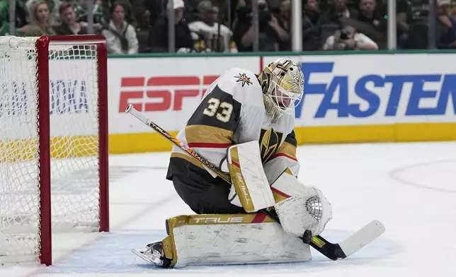 Vegas Golden Knights goaltender Adin Hill blocks a shot form the Dallas Stars in the first period in Game 5 of an NHL hockey Stanley Cup first-round playoff series in Dallas, Wednesday, May 1, 2024. (AP Photo/Tony Gutierrez)