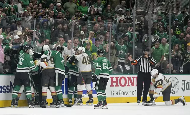 Fights break out between the Vegas Golden Knights and the Dallas Stars in the second period in Game 5 of an NHL hockey Stanley Cup first-round playoff series in Dallas, Wednesday, May 1, 2024. (AP Photo/Tony Gutierrez)