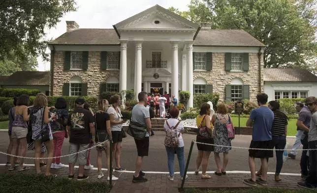 FILE - Fans wait in line outside Graceland Tuesday, Aug. 15, 2017, in Memphis, Tenn. A Tennessee judge on Wednesday, May 22, 2024, blocked the auction of Graceland, the former home of Elvis Presley, by a company that claimed his estate failed to repay a loan that used the property as collateral. (AP Photo/Brandon Dill, File)