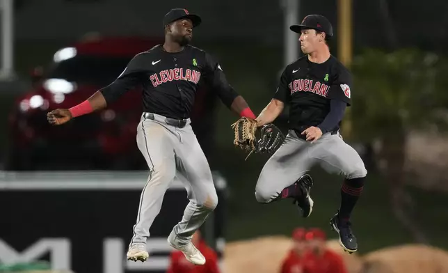 Cleveland Guardians left fielder Estevan Florial, left, and right fielder Will Brennan celebrate after a 4-3 win over the Los Angeles Angels in a baseball game in Anaheim, Calif., Saturday, May 25, 2024. (AP Photo/Ashley Landis)