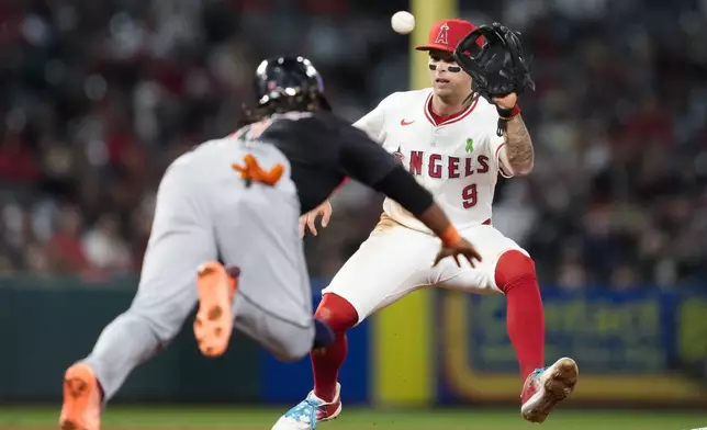 Cleveland Guardians' José Ramírez, left, is caught stealing second by Los Angeles Angels shortstop Zach Neto (9) during the eighth inning of a baseball game in Anaheim, Calif., Saturday, May 25, 2024. (AP Photo/Ashley Landis)