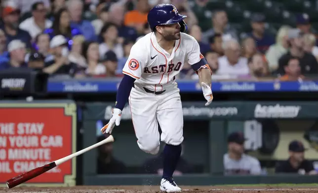 Houston Astros' Jose Altuve flips his bat as he watches his RBI single, scoring Mauricio Dubon, against the Cleveland Guardians during the sixth inning of a baseball game Wednesday, May 1, 2024, in Houston. (AP Photo/Michael Wyke)