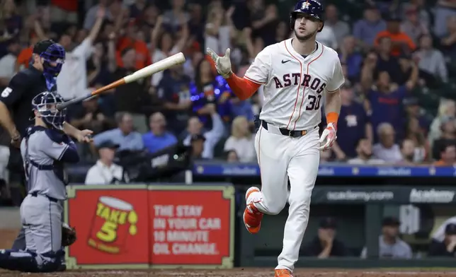 Houston Astros Kyle Tucker (30) flips his bat as he rounds the bases on his home run against the Cleveland Guardians during the seventh inning of a baseball game Wednesday, May 1, 2024, in Houston. (AP Photo/Michael Wyke)