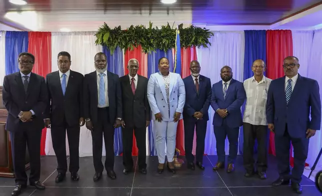 Transitional Council members pose for a group photo after a ceremony to name its president and a prime minister in Port-au-Prince, Haiti, Tuesday, April 30, 2024. The transitional council will act as the country’s presidency until it can arrange presidential elections sometime before it disbands, which must be by February 2026. (AP Photo/Odelyn Joseph)