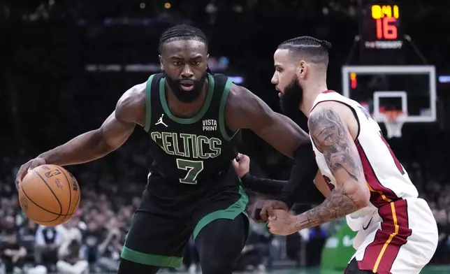 Boston Celtics guard Jaylen Brown (7) sets to drive against Miami Heat forward Caleb Martin during the first half of Game 5 of an NBA basketball first-round playoff series, Wednesday, May 1, 2024, in Boston. (AP Photo/Charles Krupa)