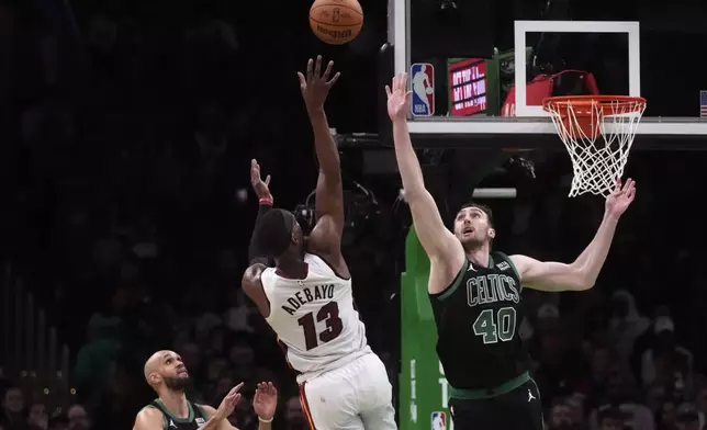 Miami Heat center Bam Adebayo (13) tries to shoot over Boston Celtics center Luke Kornet (40) during the first half of Game 5 of an NBA basketball first-round playoff series, Wednesday, May 1, 2024, in Boston. (AP Photo/Charles Krupa)