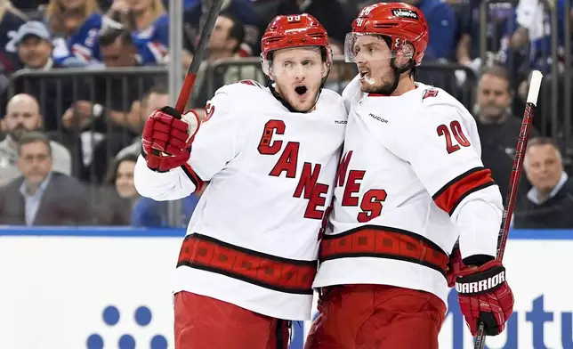 Carolina Hurricanes centers Jake Guentzel (59) and Sebastian Aho (20) celebrate Guentzel's goal during the first period in Game 2 of an NHL hockey Stanley Cup second-round playoff series against the New York Rangers, Tuesday, May 7, 2024, in New York. (AP Photo/Julia Nikhinson)