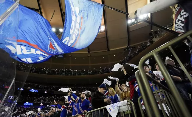 New York Rangers fans cheer the team on following a goal during the first period in Game 1 of an NHL hockey Stanley Cup second-round playoff series against the Carolina Hurricanes, Sunday, May 5, 2024, in New York. (AP Photo/Julia Nikhinson)