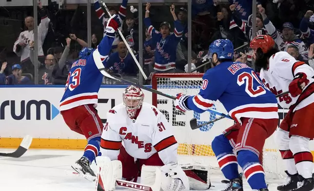 Carolina Hurricanes goaltender Frederik Andersen (31) looks on as New York Rangers center Mika Zibanejad and left wing Chris Kreider celebrate following Zibanejad's goal during the first period in Game 1 of an NHL hockey Stanley Cup second-round playoff series, Sunday, May 5, 2024, in New York. (AP Photo/Julia Nikhinson)