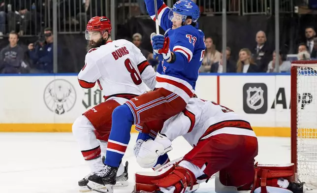 New York Rangers center Filip Chytil (72) collides with Carolina Hurricanes goaltender Frederik Andersen (31) during the second period in Game 2 of an NHL hockey Stanley Cup second-round playoff series Tuesday, May 7, 2024, in New York. At left is Hurricanes defenseman Brent Burns. (AP Photo/Julia Nikhinson)