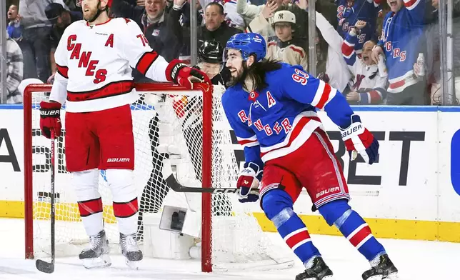 New York Rangers center Mika Zibanejad, right, celebrates after his goal as Carolina Hurricanes defenseman Jaccob Slavin (74) looks on during the first period in Game 1 of an NHL hockey Stanley Cup second-round playoff series, Sunday, May 5, 2024, in New York. (AP Photo/Julia Nikhinson)