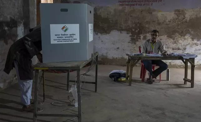A man casts his vote during the third round of voting in the six-week-long general election in Agra, Uttar Pradesh, India, Tuesday, May 7, 2024. (AP Photo/Altaf Qadri)