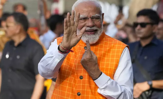 Indian Prime Minister Narendra Modi, shows the indelible ink mark on his index finger after casting his vote during the third phase of general elections, in Ahmedabad, Gujarat, India, Tuesday, May 7, 2024. (AP Photo/Ajit Solanki)