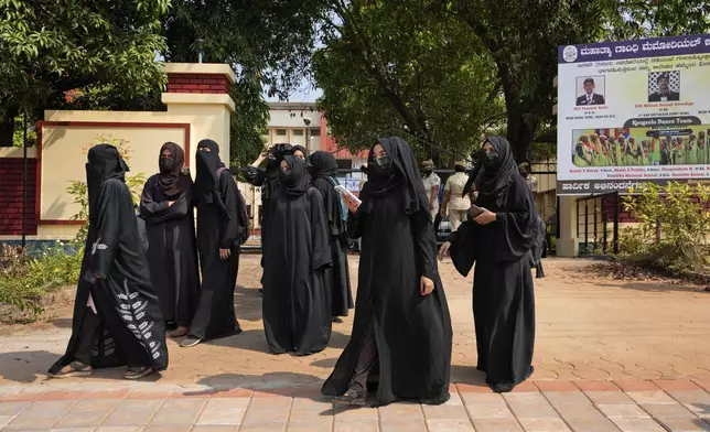 FILE- Muslim students leave Mahatma Gandhi Memorial college after they were denied entry into the campus for wearing the burqa in Udupi, Karnataka state, India, on Feb. 24, 2022. (AP Photo/Aijaz Rahi, File)