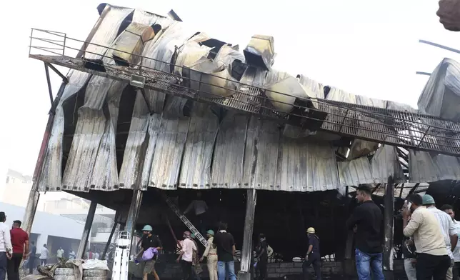 Firefighters douse a fire which broke out in an amusement park, in Rajkot in the Indian state of Gujarat, Saturday, May 25, 2024. A massive fire broke out on Saturday in a fun park in western India, killing more than ten people and injuring some others, news reports said. (AP Photo/Chirag Chotaliya)