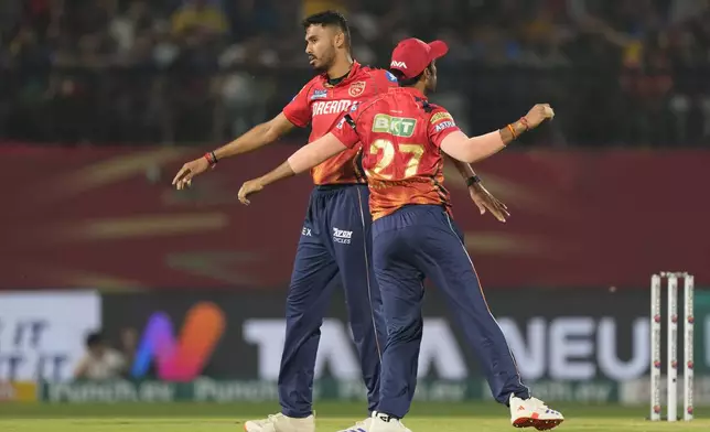 Punjab Kings' Vidwath Kaverappa, left, celebrates with teammate Shashank Singht he wicket of Royal Challengers Bengaluru's Will Jacks during the Indian Premier League cricket match between Punjab Kings and Royal Challengers Bengaluru in Dharamshala, India, Thursday, May 9, 2024. (AP Photo /Ashwini Bhatia)