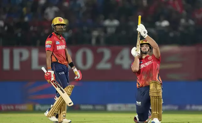 Punjab Kings' Rilee Rossouw, right, celebrates his fifty runs as teammate Shashank Singh looks on during the Indian Premier League cricket match between Punjab Kings and Royal Challengers Bengaluru in Dharamshala, India, Thursday, May 9, 2024. (AP Photo /Ashwini Bhatia)