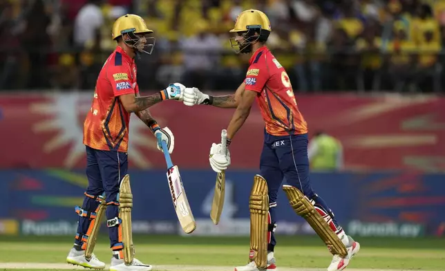 Punjab Kings' Harpreet Brar, right, and teammate Rahul Chahar touch gloves as they bat during the Indian Premier League cricket match between Chennai Super Kings and Punjab Kings in Dharamshala, India, Sunday, May 5, 2024. (AP Photo /Ashwini Bhatia)