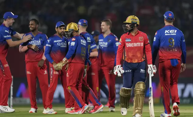 Punjab Kings' Jitesh Sharma, second right, walks off the field after losing his wicket during the Indian Premier League cricket match between Punjab Kings and Royal Challengers Bengaluru in Dharamshala, India, Thursday, May 9, 2024. (AP Photo /Ashwini Bhatia)