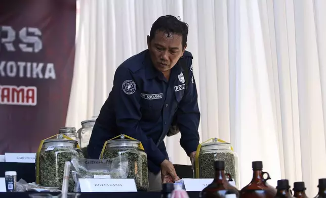 A police officer displays evidence during a news conference at a villa in Canggu, Bali, Indonesia on Monday, May 13, 2024. Indonesian police raided what they said was a major drug lab hidden in a villa on the resort island of Bali, and arrested four people. (AP Photo/Firdia Lisnawati)