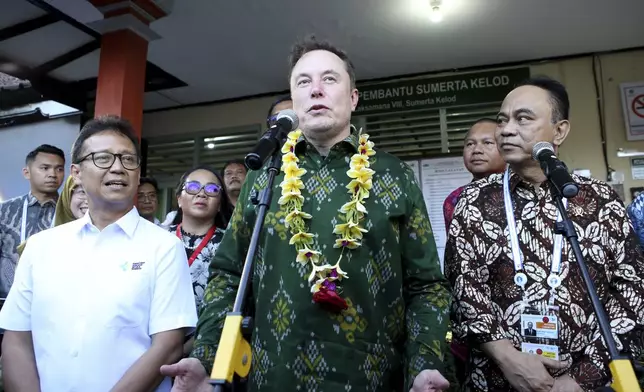 Elon Musk center, talks to press media during the launch of Starlink satellite internet service, at a public health center in Denpasar, Bali, Indonesia on Sunday, May 19, 2024. Elon Musk arrived in Indonesia's resort island of Bali to launch Starlink satellite internet service in the world's largest archipelago nation. (AP Photo/Firdia Lisnawati)