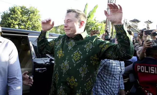 Elon Musk gesture upon his arrival at a public health center at Denpasar, Bali, Indonesia, on Sunday, May 19, 2024. Elon Musk arrived in Indonesia's resort island of Bali to launch Starlink satellite internet service in the world's largest archipelago nation. (AP Photo/Firdia Lisnawati)