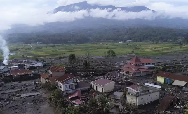 This drone photo shows the damage at a village affected by a flash flood in Agam, West Sumatra, Indonesia, Tuesday, May 14, 2024. Rescuers on Tuesday searched in rivers and the rubble of devastated villages for bodies, and whenever possible, survivors of flash floods that hit Indonesia's Sumatra Island over the weekend. (AP Photo/Sutan Malik Kayo)