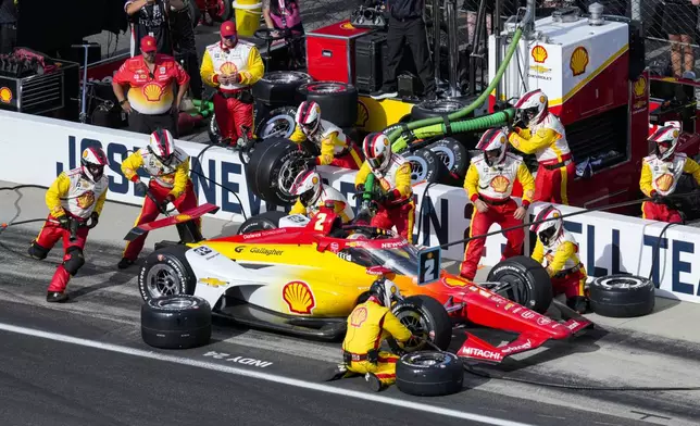 Josef Newgarden makes a pit stop during the Indianapolis 500 auto race at Indianapolis Motor Speedway in Indianapolis, Sunday, May 26, 2024. (AP Photo/AJ Mast)